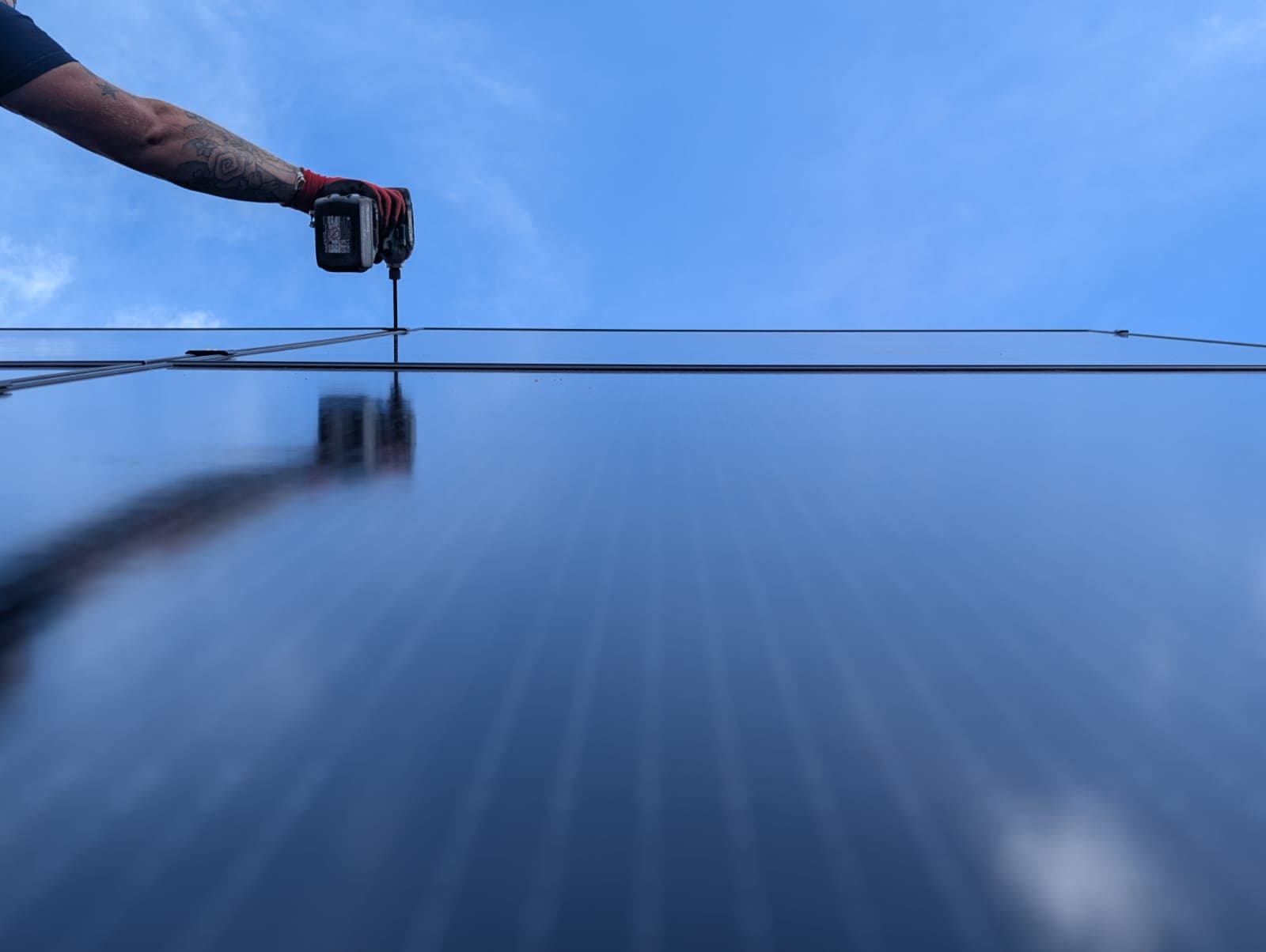 Close-up of a solar panel being fitted to a roof