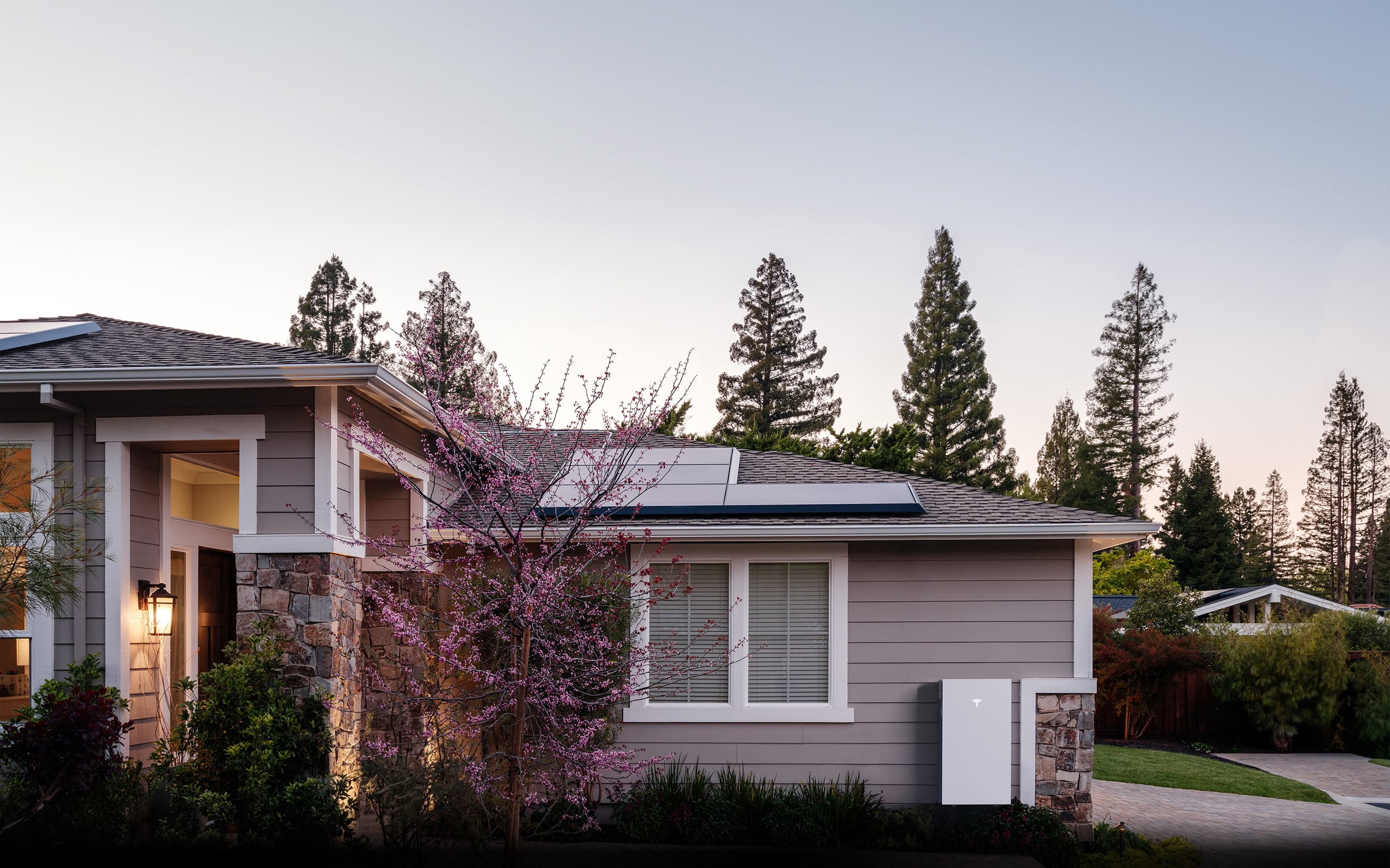 A Tesla Powerwall 3 mounted on the exterior wall of a home